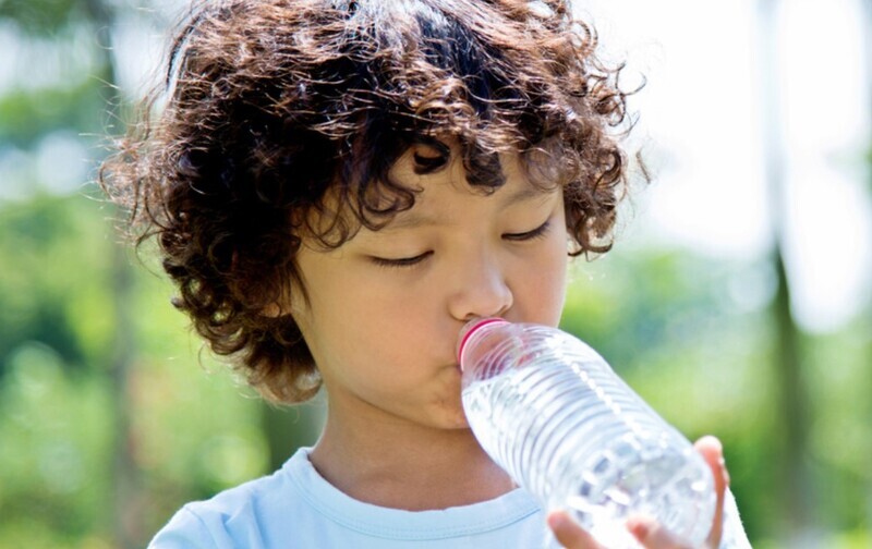 boy with autism holding a water bottle