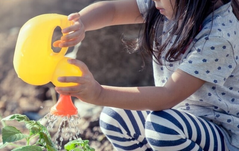 autistic child watering plants